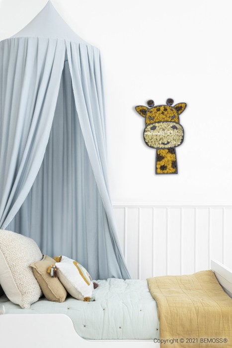 Een gezellige kinderkamer is voorzien van een lichtblauwe hemel boven het bed. Het bed heeft witte en beige kussens, samen met een mosterdgele deken. Aan de muur hangt een decoratieve giraffenkop gemaakt van bloemen, aangevuld met een levendige BEMOSS-mosschilderij. De afbeelding is auteursrechtelijk beschermd door BEMOSS® in 2021.